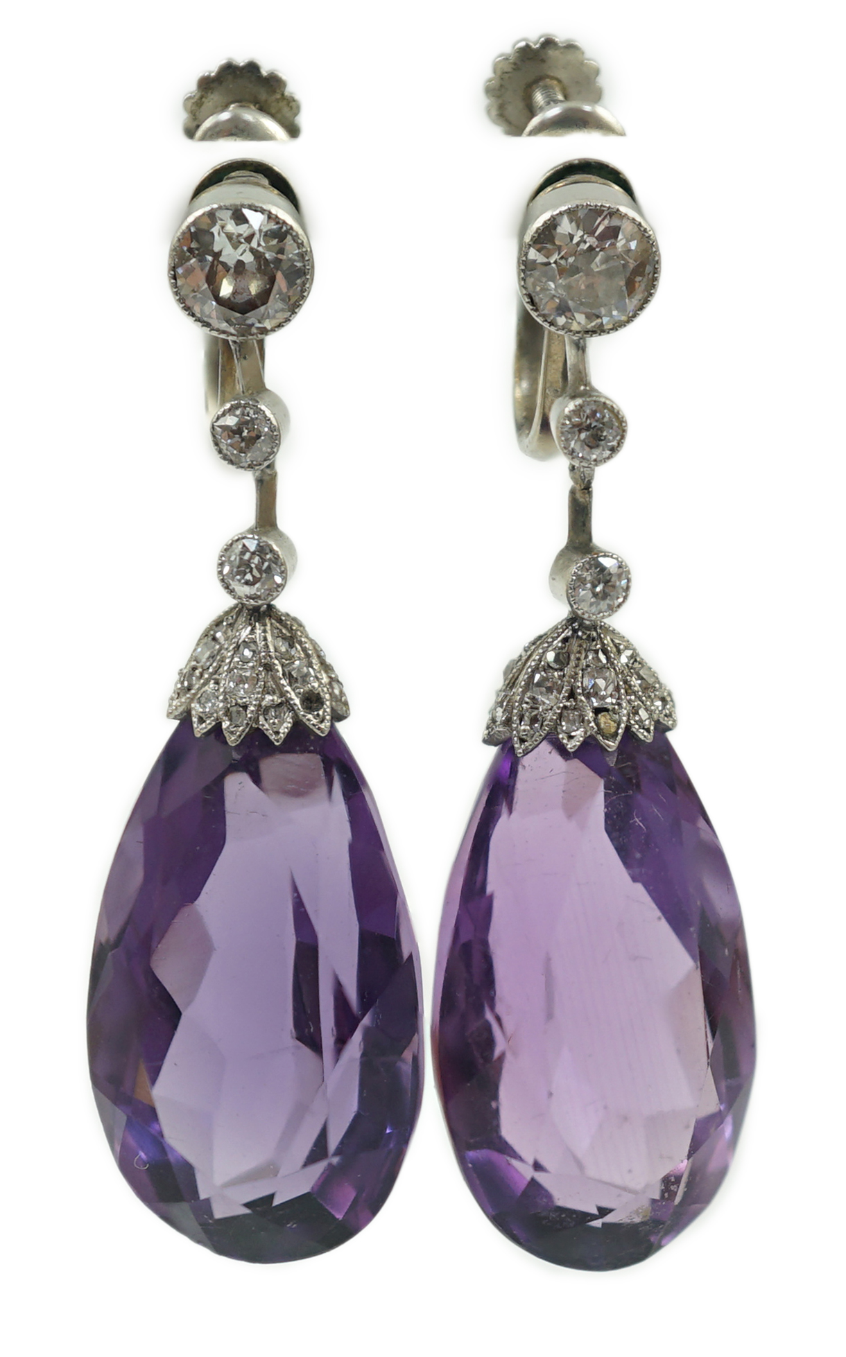 A pair of 1920's platinum?, single stone pear cut amethyst and millegrain round cut diamond set drop ear clips